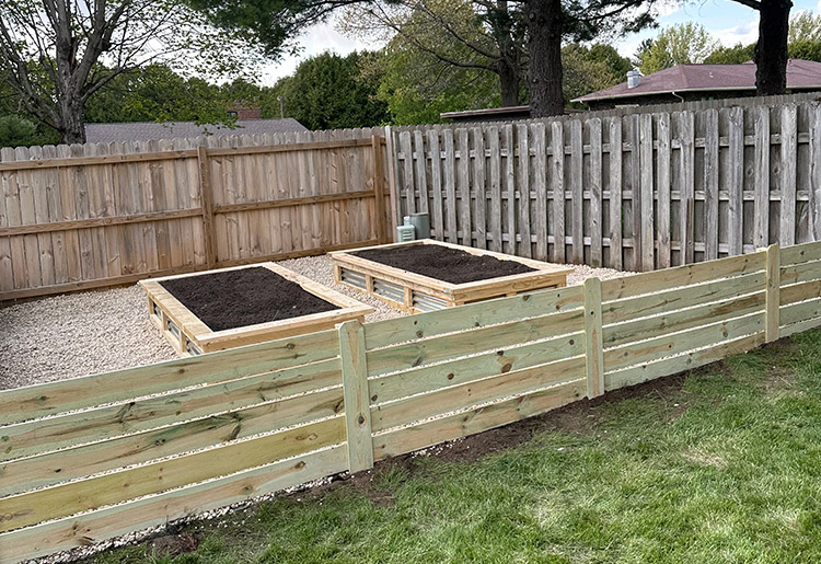 Custom-built cedar raised garden box installed in a backyard in Rockford, IL.