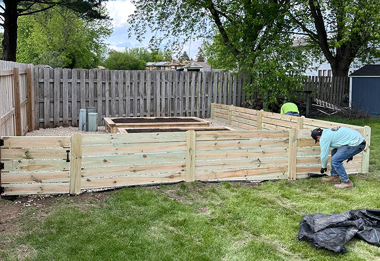 Handcrafted premium lumber garden boxes designed to fit a custom residential backyard layout.