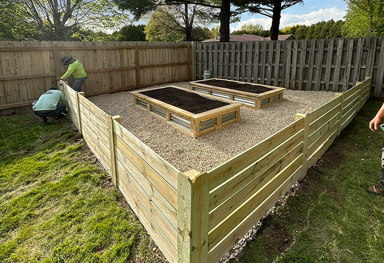 Large tiered raised garden bed prepared with premium organic soil for vegetable planting in Machesney Park.